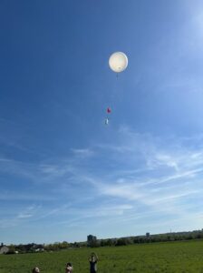 a radiosonde being launched into the blue sky